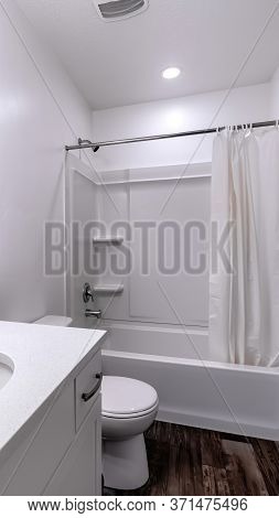 Vertical Clean White Bathroom Interior With Oval Sink Mirror Toilet Bathtub And Shower