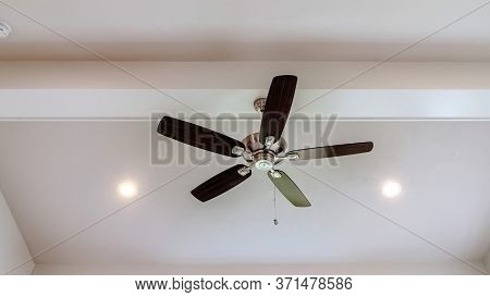 Panorama Ceiling Fan With Wood Blades And Built In Lights On The Ceiling Beam Of Home