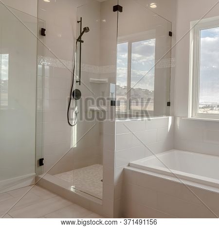 Square Built In Bathtub With Black Faucet And Shower Stall With Half Glass Enclosure