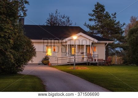 Typical Finnish style countryside house at night. Cozy summer house at night in Finland