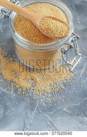 Jar Of Raw Amaranth Grain With A Spoon Close Up