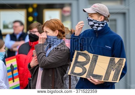 Richmond, North Yorkshire, Uk - June 14, 2020: Two Blm Protesters Adjust Their Protective Face Cover