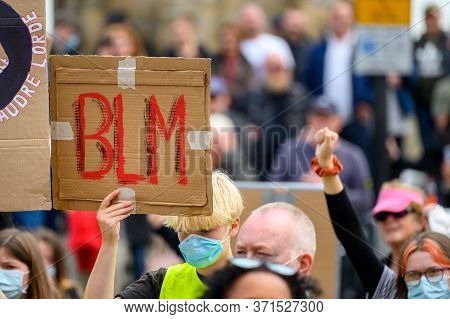 Richmond, North Yorkshire, Uk - June 14, 2020: A Protester Wears A Ppe Face Mask And Holds A Homemad