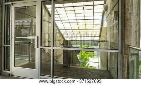 Panorama Glass Door And Wall With View Of Slanted Frosted Roof Over Stairway Of Building