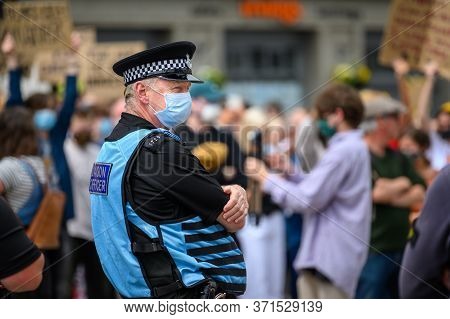 Richmond, North Yorkshire, Uk - June 14, 2020: A Police Liaison Officer Wears A Ppe Face Mask At A B