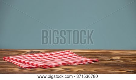Checkered Red Cotton Napkin On A Wooden Table