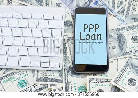 Keyboard And Modern Phone On Money Background, Paycheck Protection Program Concept