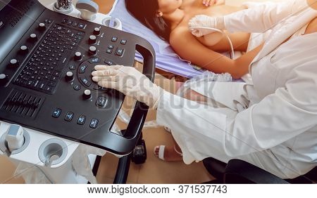 Gynecologist Performing Breast Examination For Her Patient Using Ultrasound