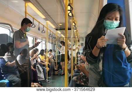 Bangkok, Thailand - June 15 : Asian Students And Passengers In Public Sky Train Wearing Hygiene Face