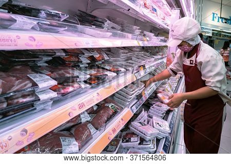 Bangkok, Thailand - June 15, 2020 : Asian Woman Shop Assistant Wearing Hygiene Face Mask Are Restock