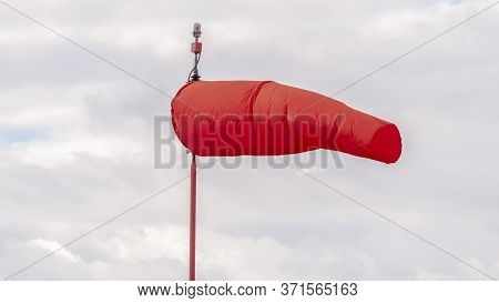 Panorama Crop Red Wind Sock At An Airport Blowing In The Wind