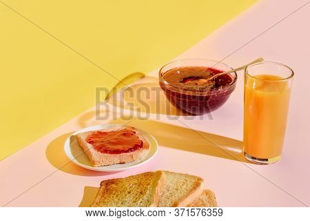 Breakfast Of Toasts With Jam And Orange Juice On A Bright Pink And Yellow Background, Laden With The