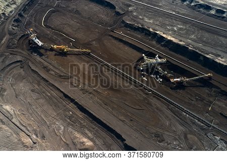 Aerial Shoot Of Quarry With Heavy Bucket Wheel Excavators Mining A Coal. Heavy Industry Concept.