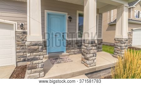 Panorama Stape And Arched Entrance At The Porch Of Home With Pastel Blue Front Door