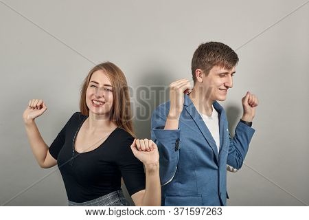 Arms Up Celebrating Success Fists In Exultation. Young Attractive Couple Boyfriend Girlfriend Two Pe