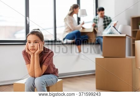 mortgage, family and real estate concept - sad girl moving to new home with mother and father packing things