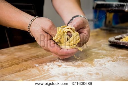 Chef Rolling Dough With A Pasta Machine. Pasta Maker Machine.