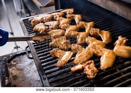 Fried Chiken Wings At Grill Barbecue. Restaurant.