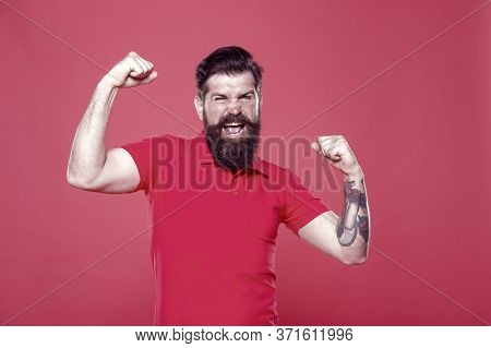 Strength And Drive. Bearded Man Show Strength. Strong Hipster Flex Arms Red Background. Strength And