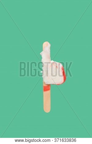 Red Chocolate Outer Popsicle With The Last Bit On Green Background