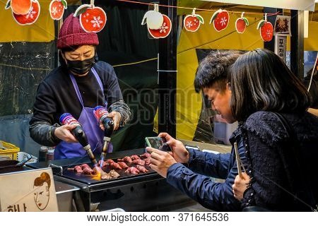 Daegu , South Korea, April 4, 2019: Tourist Taking Picture While Chef Burn A Slice Of Wagyu Beef Wit