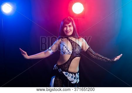 Girl Dancing Belly Dance, Fusion Or Tribal. A Woman In A Beautiful Costume Demonstrates Charming And