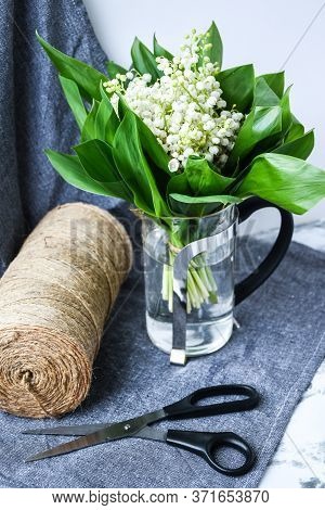 Spring Bouquet Of Lilies Of The Valley With Scissors Rope In A Flower Shop, White Flowers And Green 