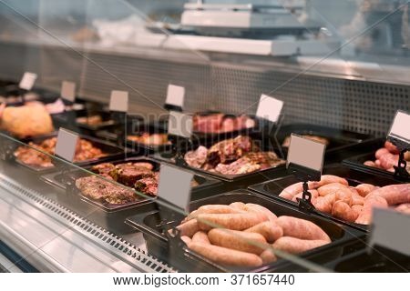 Close Up Of Raw Meat Pieces And Meat Products In Refrigerator With Price Tags Ready For Sale In Meat
