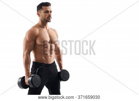 Portrait Of Shirtless Tensed Male Bodybuilder Holding Dumbbells In Arms, Looking Straight. Man With 
