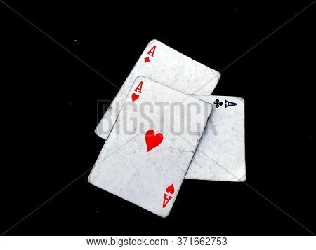 Set Of Four Aces Playing Cards Suits. Winning Poker Hand Isolated On Black Background