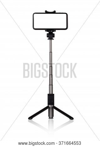 Smartphone With A White Cut-out Screen On A Monopod. Selfie Stick And Smartphone On A White Backgrou