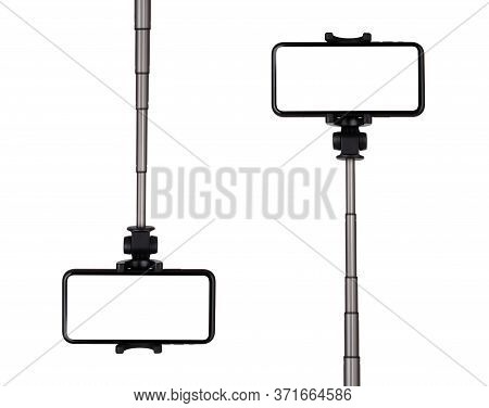 Smartphone With A White Cut-out Screen On A Monopod. Selfie Stick And Smartphone On A White Backgrou