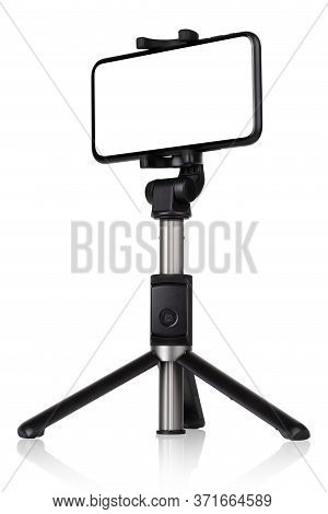 Smartphone With A White Cut-out Screen On A Monopod. Selfie Stick And Smartphone On A White Backgrou