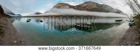 Autumn Fog With Boats At Sylvenstein Reservoir In Bavaria
