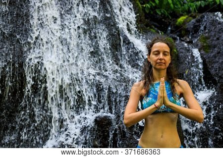 Namaste Mudra. Close Up. Yoga Near Waterfall. Young Woman Meditating, Practicing Yoga And Pranayama 