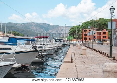 Walking Promenade Of Starigrad, Hvar, Old Boats Docked In The Harbour, Straight Line Leading Through