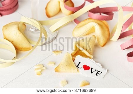 Cookies Shaped Like Tortellini With The Word Love Written On A Paper And A Glass Of Champagne With S