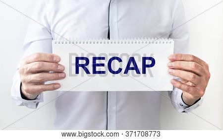 Recap Word On Planner In Male Hands On White Background. Recap Concept