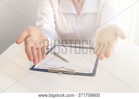 Doctor Who Explains To Patient. Explaining Hand Jestures Of A Female Doctor