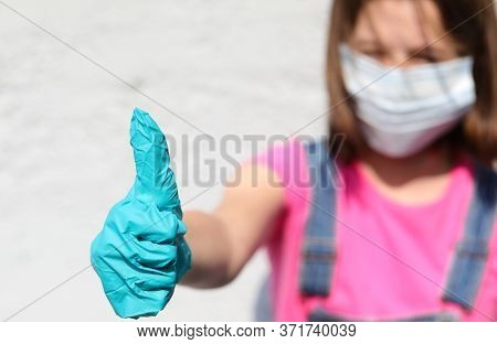 Girl With Mask And Thumb Up With Latex Glove For Protection Against Covid-19