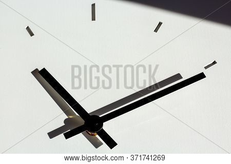 Hands Of A Wall Clock, With Shadows On White, Cementitious Background Structure. Shadow In Upper Par