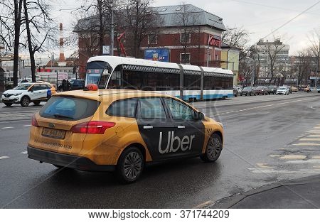 March 10, 2019 Moscow, Russia. A Yellow Uber Taxi Service Car On A Street In Moscow In Cloudy Weathe