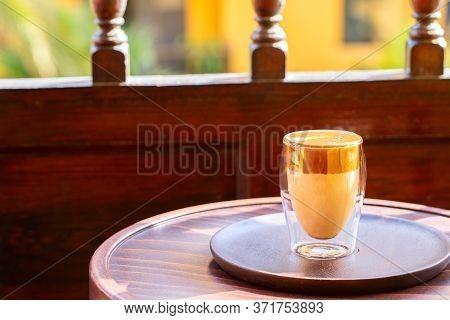 Iced Dalgona Coffee On The Terrace Table. Trendy Creamy Whipped Coffee . Ccopy Space.