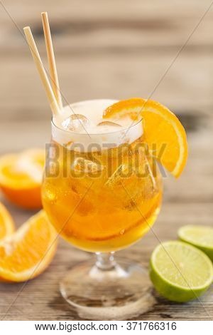 Radler With Ice, Paper Straws And Orange Wedges.