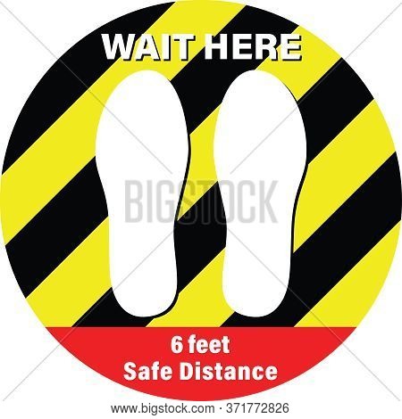 Sticker With The Text , Wait Here, 6 Feet Safe Distance. Yellow And Black Stripes Round Sticker For 