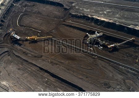 Aerial Shoot Of Quarry With Heavy Bucket Wheel Excavators Mining A Coal. Heavy Industry Concept.