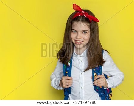 Little Beautiful Smiling School Girl In A School Uniform With A Backpack. Advertising Concept Back T