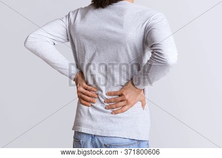 Renal Colic And Back Pain. Man Suffers From Lower Back Pain, Cropped, Studio Shot