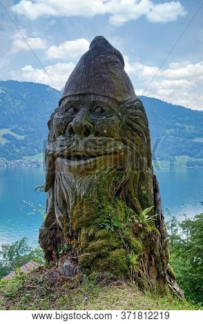 Interlaken, Switzerland - June 13, 2020: Old Gnome Or Dwarf Statue Made Of Wood, Located Near The In