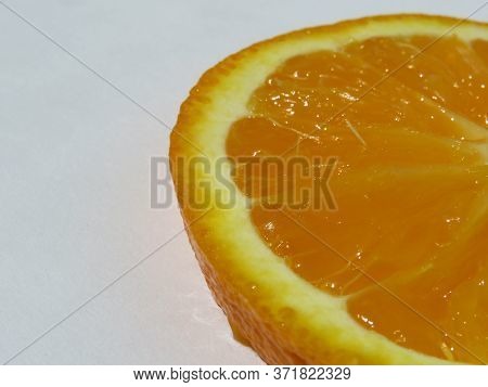 A Piece Of Orange Fruit Isolated With A White Background